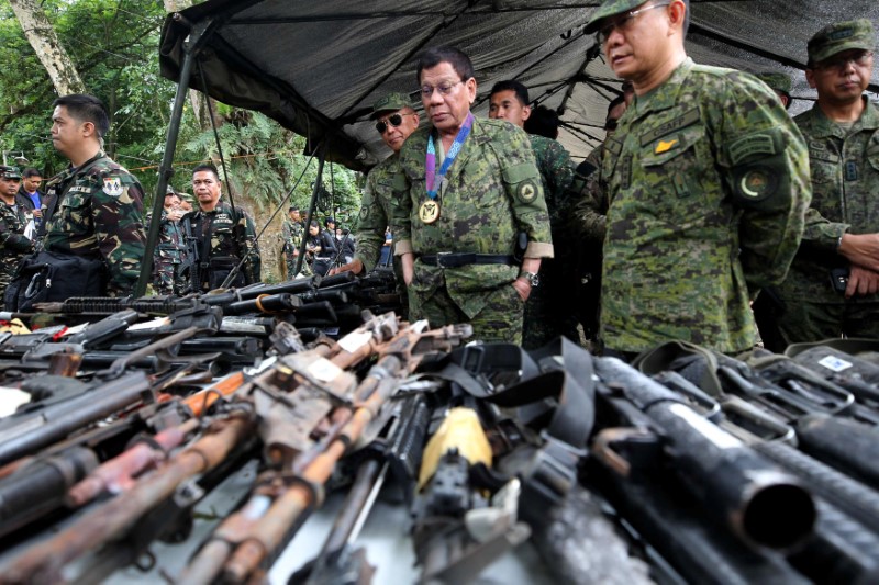 Philippine President Rodrigo Duterte inspects firearms together with Eduardo Ano, Chief of Staff of the Armed Forces of the Philippines, during his visit at the military camp in Marawi city